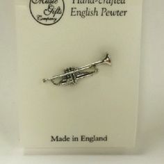 This Trumpet Pin Is Beautifully Handcrafted And Incredibly Detailed In Fine English Pewter. Would Make A Great Addition To Anyone's Musical Jewelry Ensemble! Brand New Handmade In England English Pewter 1/4" H X 1 1/8" W Tags: Music Gift, Music Accessory, Music Themed, Music Jewelry, Pewter, Pin, Trumpet, Brass, Orchestra, Band Moose Family, Musical Jewelry, Music Jewelry, Music Accessories, Music Themed, Enamel Brooch, Small Bows, Enamel Flower, Stone Gold