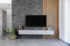 a large flat screen tv mounted to the side of a wall in a living room