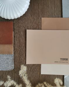 some brown and white paint samples on a table