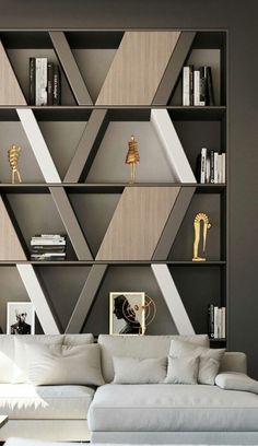 a white couch sitting in front of a book shelf