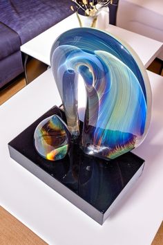 a glass sculpture sitting on top of a white table