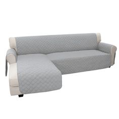 a couch with a footstool sitting next to it on top of a white floor