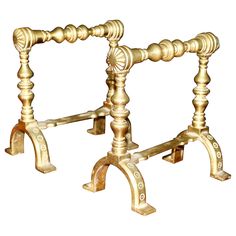 an old fashioned wooden table with two legs and one leg on the other side, in gold