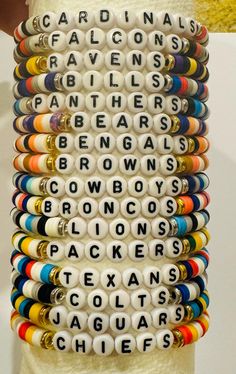 🏈Support your favorite NFL team with a customized beaded bracelet! 🏈This listing is for one bracelet. The bracelet includes clay beads matching your favorite team's colors, white beads with black letters and two flat round spacer beads in the color of your choice (gold or silver). Customize it with any word or name you would like.  🏈Details: - made with elastic cord - length: 7 inches (please specify if you would like a different length)  - closure: tie - handmade to order Thank you for your support!  Kristina Word Bracelets, Team Bracelets, Word Bracelet, Black Letter, White Beads, Clay Beads, Chicago Il, Bead Bracelet, Team Colors