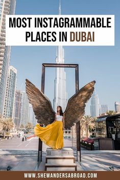 a woman standing in front of an angel statue with the words most instagrammable places in dubai