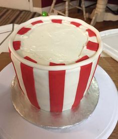 a red and white striped cake sitting on top of a plate