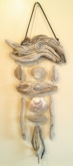 a driftwood wall hanging with shells and seashells