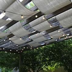 an outdoor dining area with tables and chairs under a pergolated roof over water