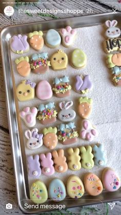 a tray filled with lots of decorated cookies