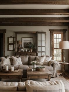 a living room filled with furniture and wooden beams