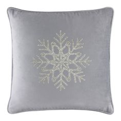 a silver pillow with a snowflake design on it