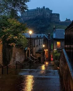 an image of a rainy street scene with castle on the hill in the back ground