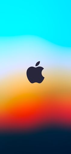 an apple logo is shown in front of a blurry background with blue, yellow and red colors