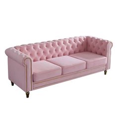 a pink velvet couch with gold trimmings and buttons on the armrests