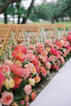 rows of chairs lined up with flowers on the back and seats down to the side