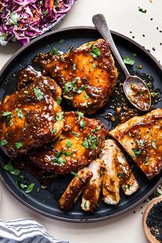 grilled pork chops on a plate with coleslaw