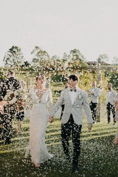 a newly married couple walking through confetti