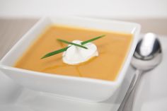 a white bowl filled with soup on top of a table