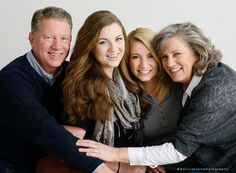 three women and one man are hugging each other