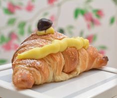 there is a croissant with cheese on it