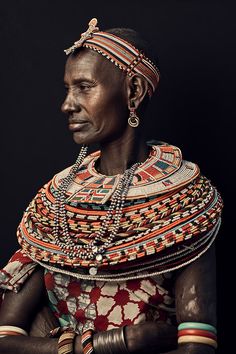 an african woman in traditional dress and jewelry