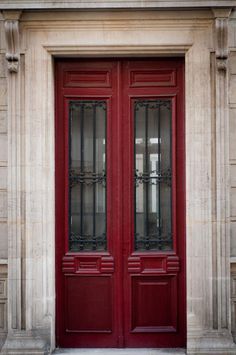 the front door to an old building with two glass doors on each side and one in between