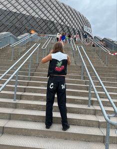 a person standing on some stairs with their back to the camera