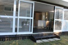 a house with white shutters on the front door