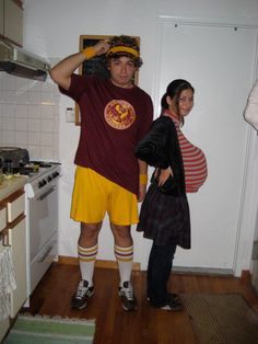 a man and woman standing in a kitchen next to each other, wearing matching outfits