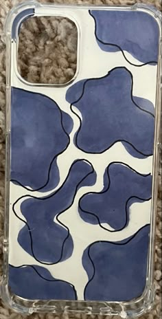 a blue and white phone case sitting on top of a carpeted floor next to a rug