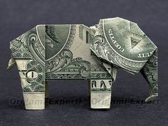 an origami elephant made out of money