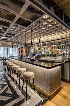 a bar with several stools in front of it