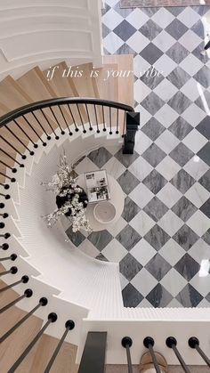 an aerial view of a spiral staircase with black and white checkered flooring on the walls