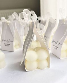 small bags filled with white candies on top of a table