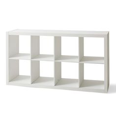 a white shelf with several shelves on each side