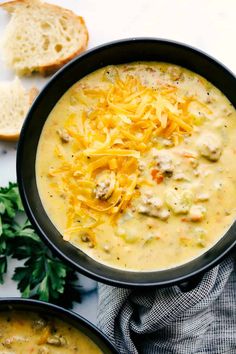 two bowls of soup with bread and parmesan cheese