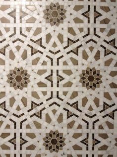 an intricately designed tile pattern in brown and white