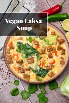 vegan laksa soup in a bowl with fresh vegetables