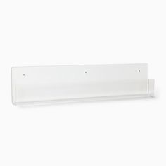 a clear plastic shelf with two hooks on the front and one hook on the back