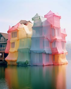 an unusual building that looks like it is floating in the water