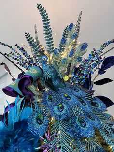 a blue and green arrangement with peacock feathers