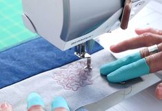 someone is using a sewing machine to sew something on a piece of fabric that has been stitched together