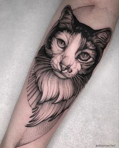 a black and white cat tattoo on the arm