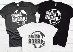 three t - shirts with the words senior and seniors printed on them, sitting next to each other