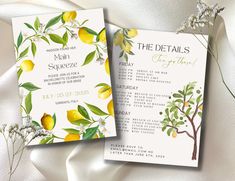 two wedding programs with lemons and flowers on white satin, next to each other