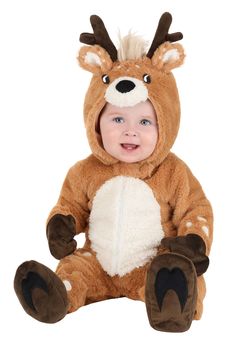 a baby wearing a reindeer costume sitting on the ground