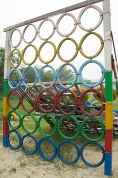 an outdoor sculpture made out of multiple colored circles and rings on top of each other