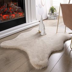 a living room with a fireplace and white rug