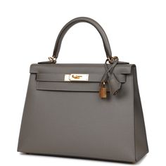 This Kelly, in the Sellier style, is in Gris Meyer epsom leather with gold hardware and has tonal stitching, front flap, two straps with center toggle closure, clochette with lock and two keys a single rolled handle and removable shoulder strap.The interior is lined with Gris Meyer chevre leather and has one zip pocket with an Hermes engraved pull and two open pockets on the opposite side.Collection: UOrigin: FranceCondition: New and never worn (plastic on hardware)Accompanied by: Hermes box, He Kelly Sellier, Luxury Bags Collection, Hermes Box, Kelly Bag, Birkin 25, Luxury Handbags, Wallet Case, Gold Hardware, Luxury Bags