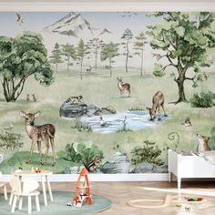 a child's room with a deer mural on the wall